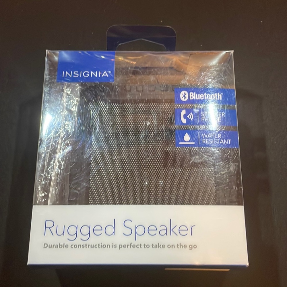 It is a small, black Bluetooth speaker that is waterproof.